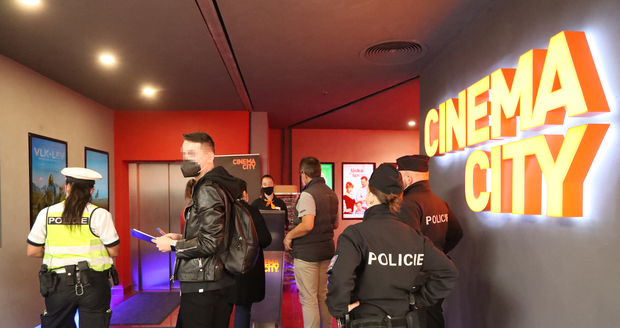 Control of compliance with anti-epidemic measures in a multiplex cinema in the center of Prague.  Hygiene staff checked that people had evidence of infectivity or respirators.