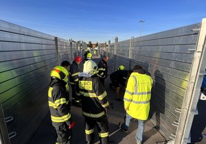 Firefighters practice the construction of flood defenses and water pumping.